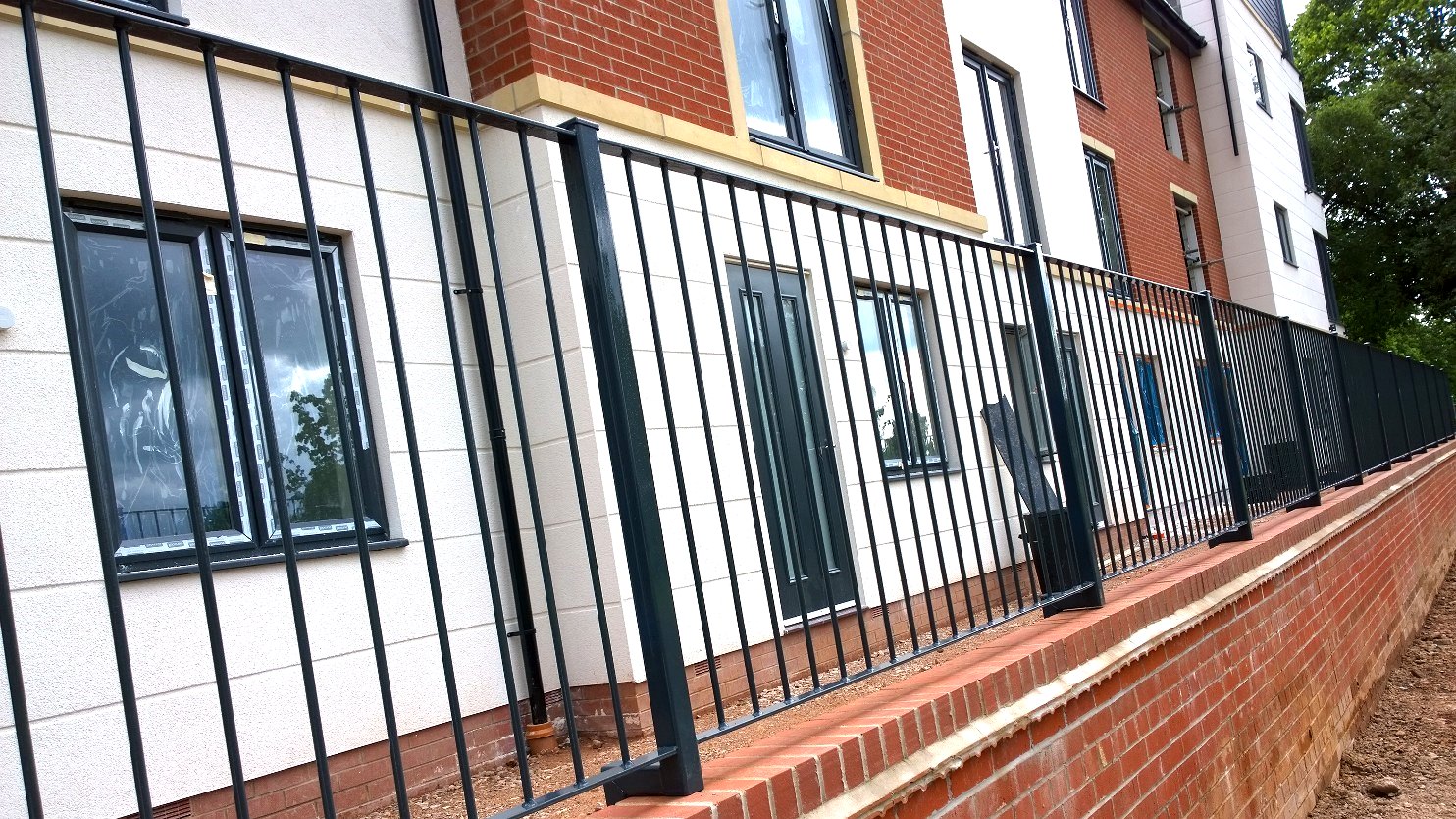External powder-coated metal railings to a brick parapet wall on the development, Radlett